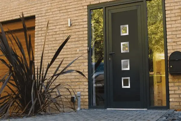 Anthracite grey front door with glazed panels on a brick house