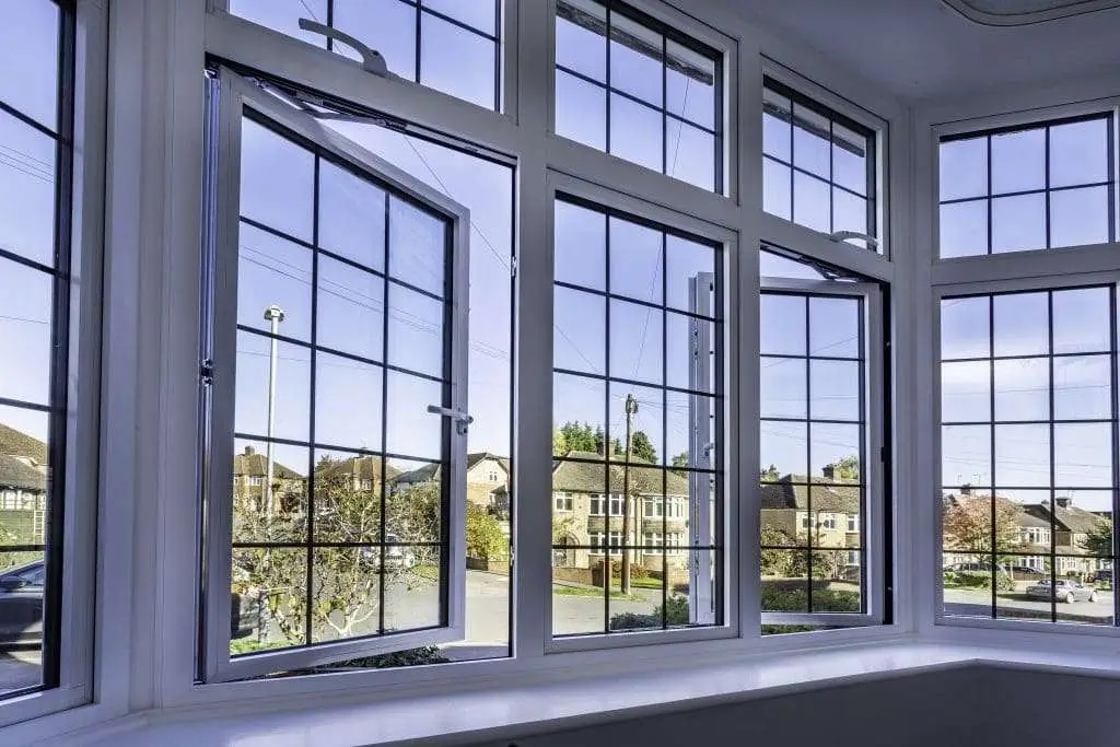 White uPVC casement windows with Georgian bars in a bright bay