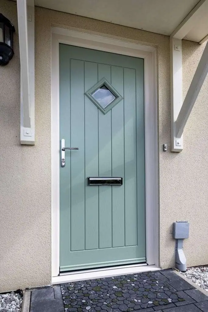 Sage green composite front door with a glazed top panel